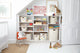 Storage shelf in playroom with Pehr storage of various sizes and styles.
