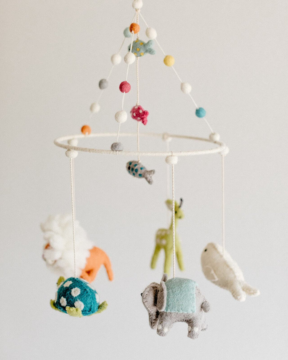 Close up of Pehr Noah's Ark Classic Mobile in Baby Nursery. Ethically Handmade using 100% wool and AZO-Free dyes. Mobile with Animals.